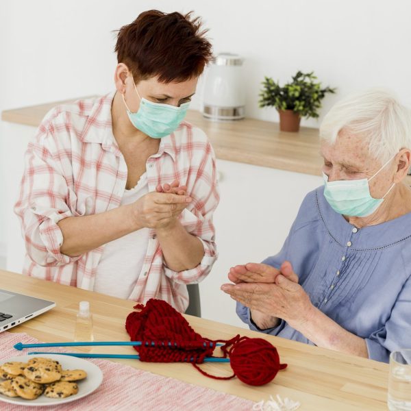 elder-women-sanitizing-their-hands-home